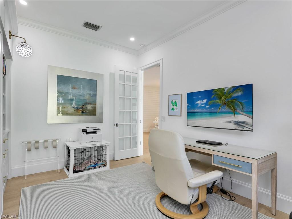 4304 Kensington High Street Naples, FL 34105 - Photo 6 of 40 a living room with furniture a fireplace and a flat screen tv