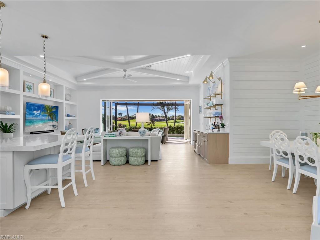 4304 Kensington High Street Naples, FL 34105 - Photo 9 of 40 a dining room with furniture and a chandelier