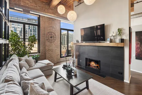 a living room with furniture a fireplace and a flat screen tv