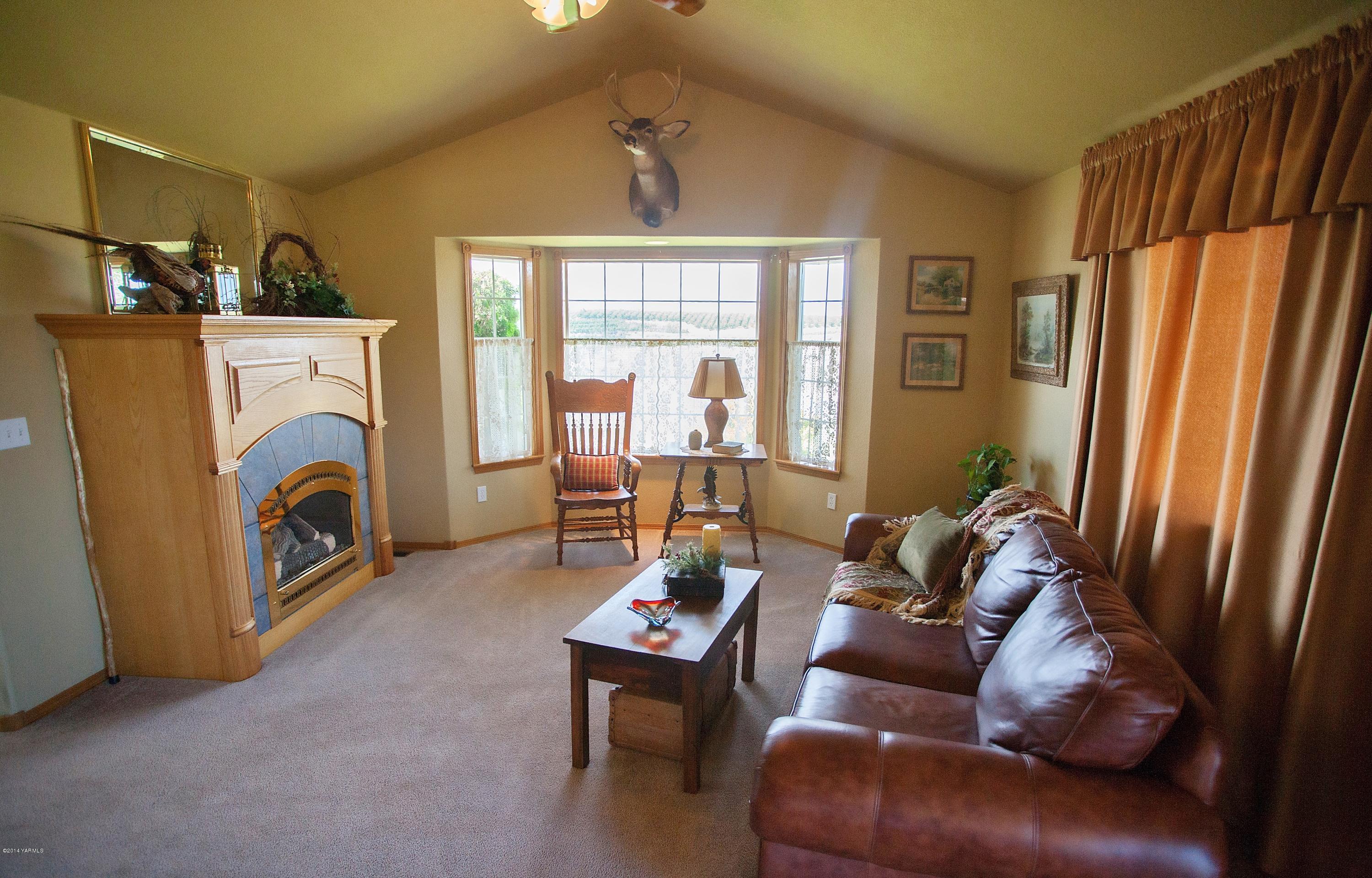 16353 Ahtanum Road Yakima, WA 98903 - Photo 5 of 46 a living room with furniture a fireplace and a large window