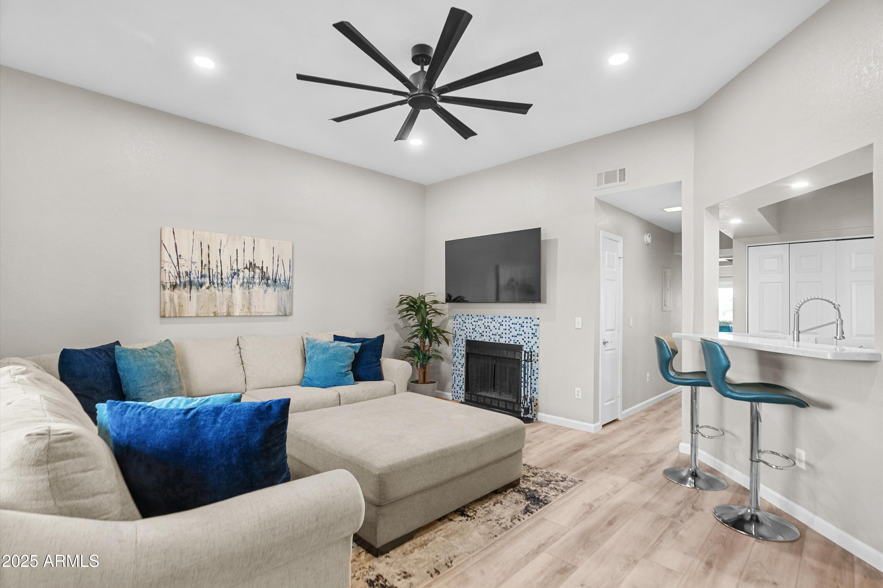 a living room with furniture kitchen view and a fireplace