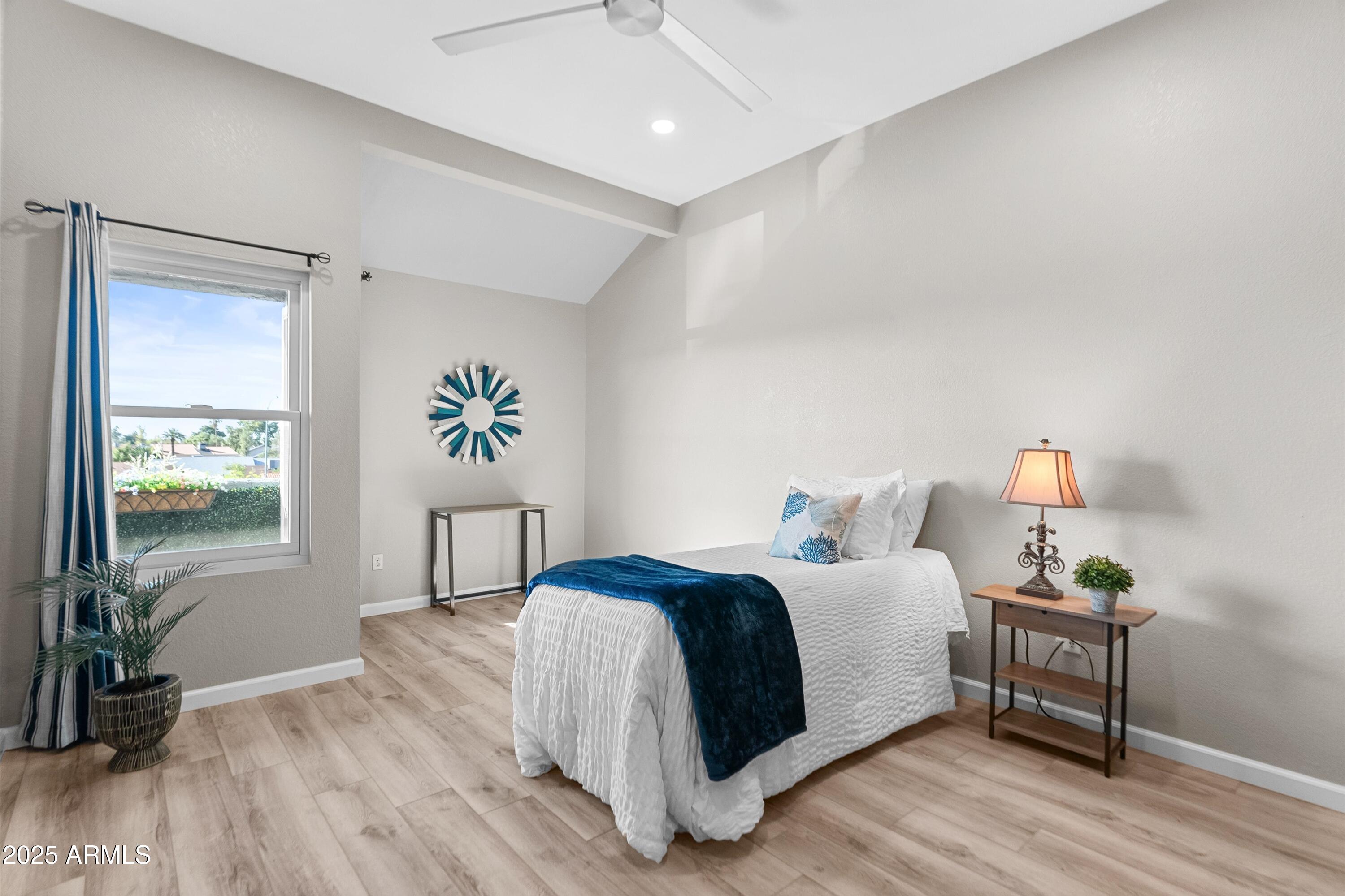 1331 West Baseline Road, Unit 338 Mesa, AZ 85202 - Photo 13 of 28 a bedroom with a bed and wooden floor