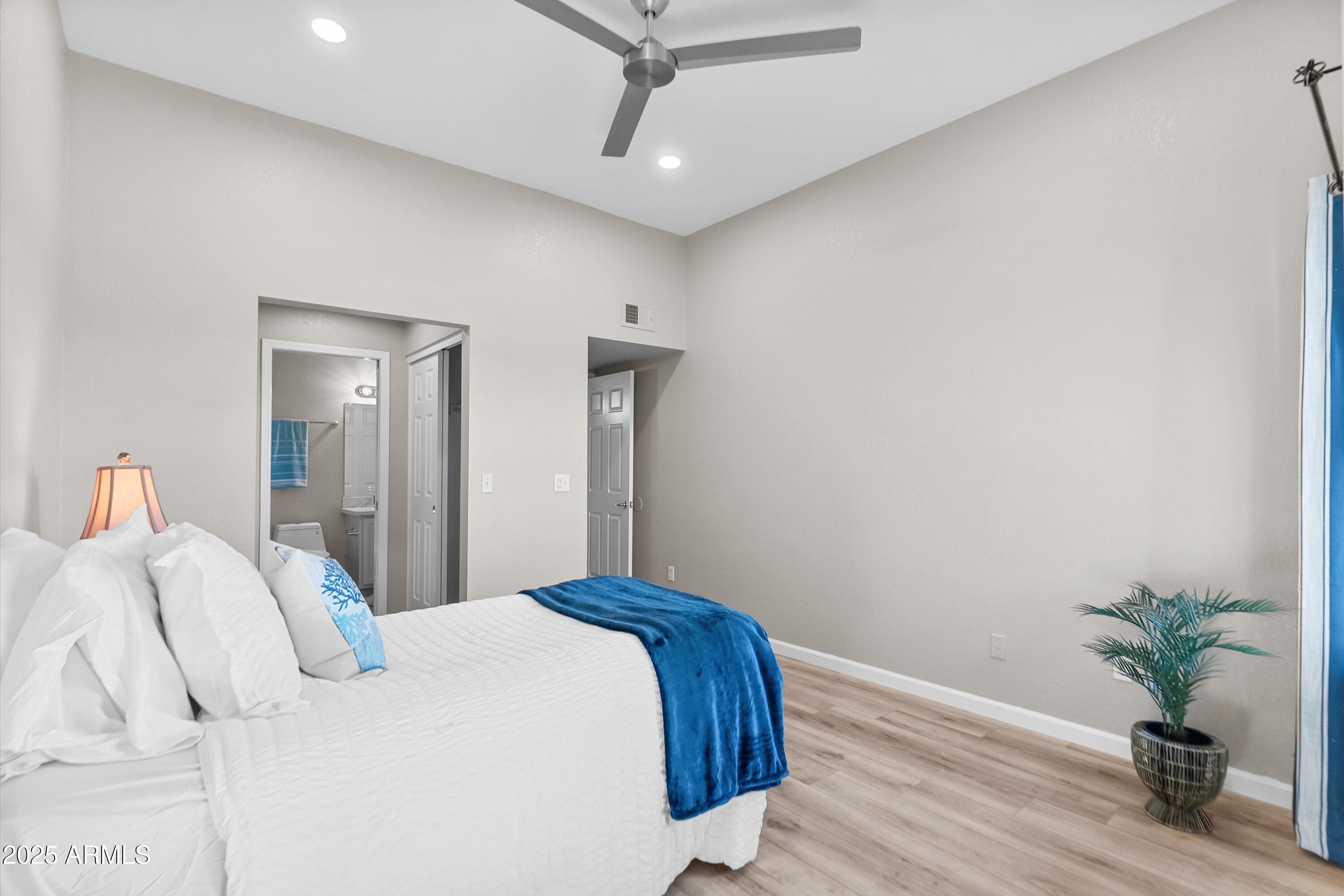 1331 West Baseline Road, Unit 338 Mesa, AZ 85202 - Photo 14 of 28 a bedroom with a bed and a potted plant