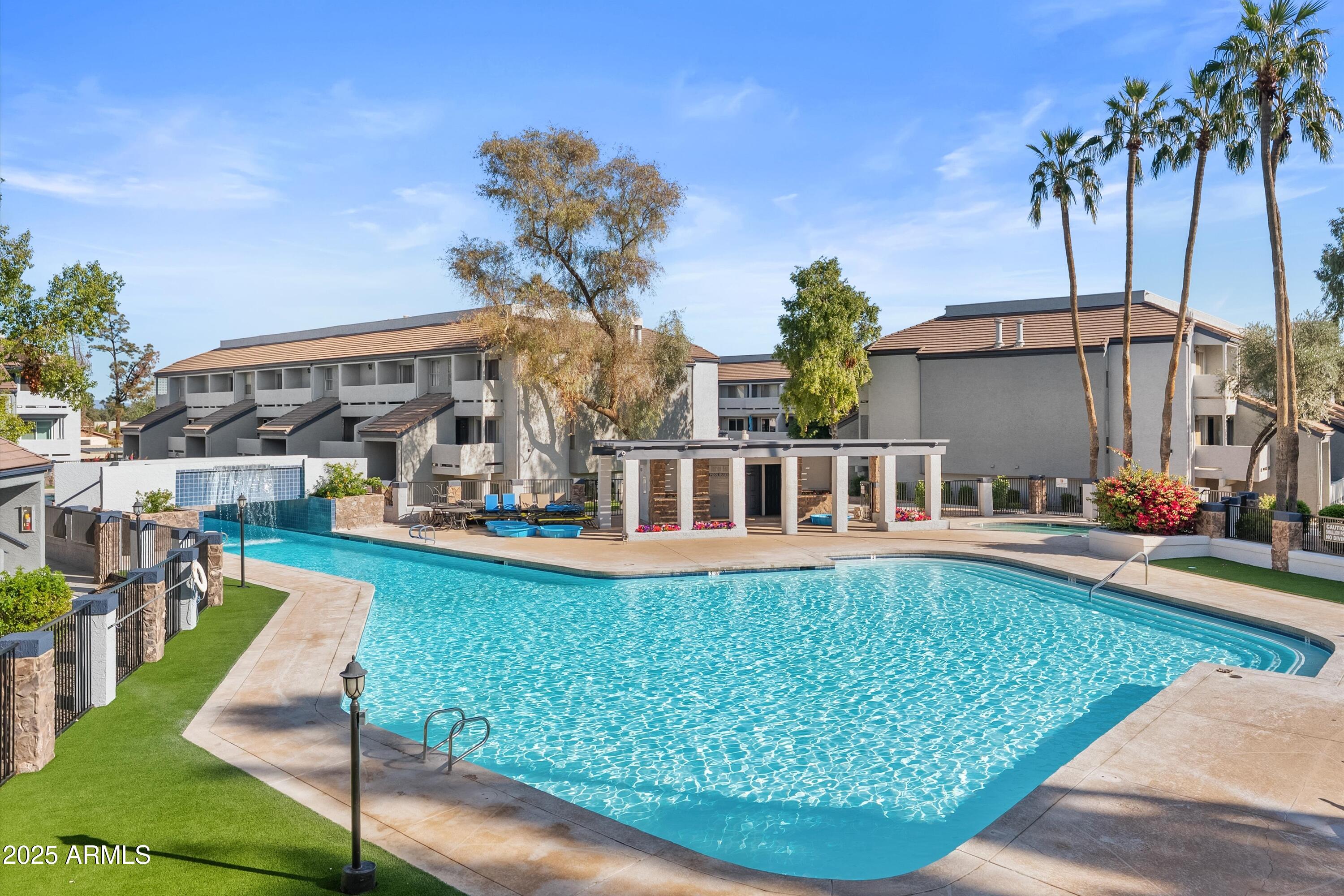 1331 West Baseline Road, Unit 338 Mesa, AZ 85202 - Photo 18 of 28 a front view of a house with swimming pool having outdoor seating