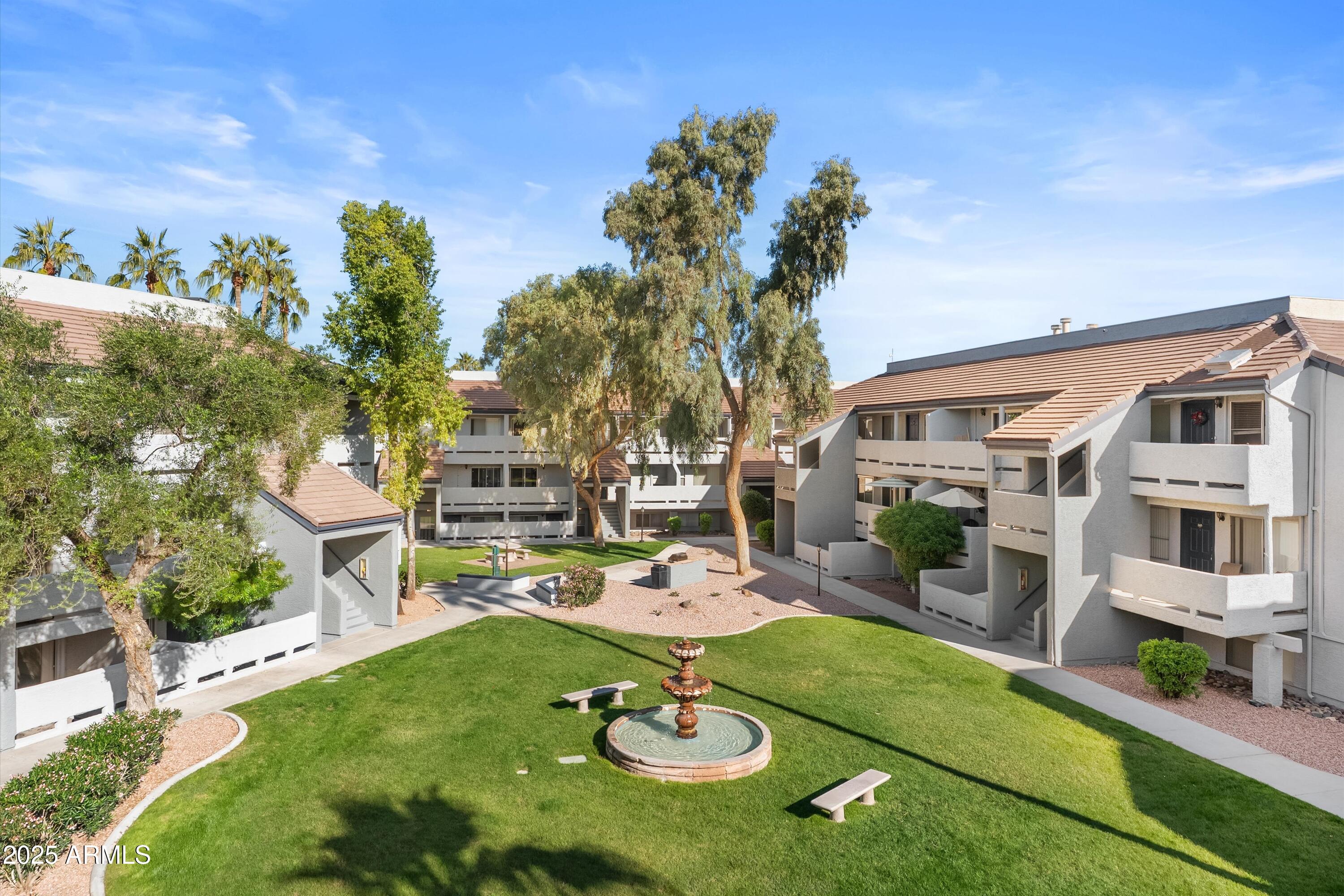 1331 West Baseline Road, Unit 338 Mesa, AZ 85202 - Photo 21 of 28 a backyard of a house with fireplace table and chairs