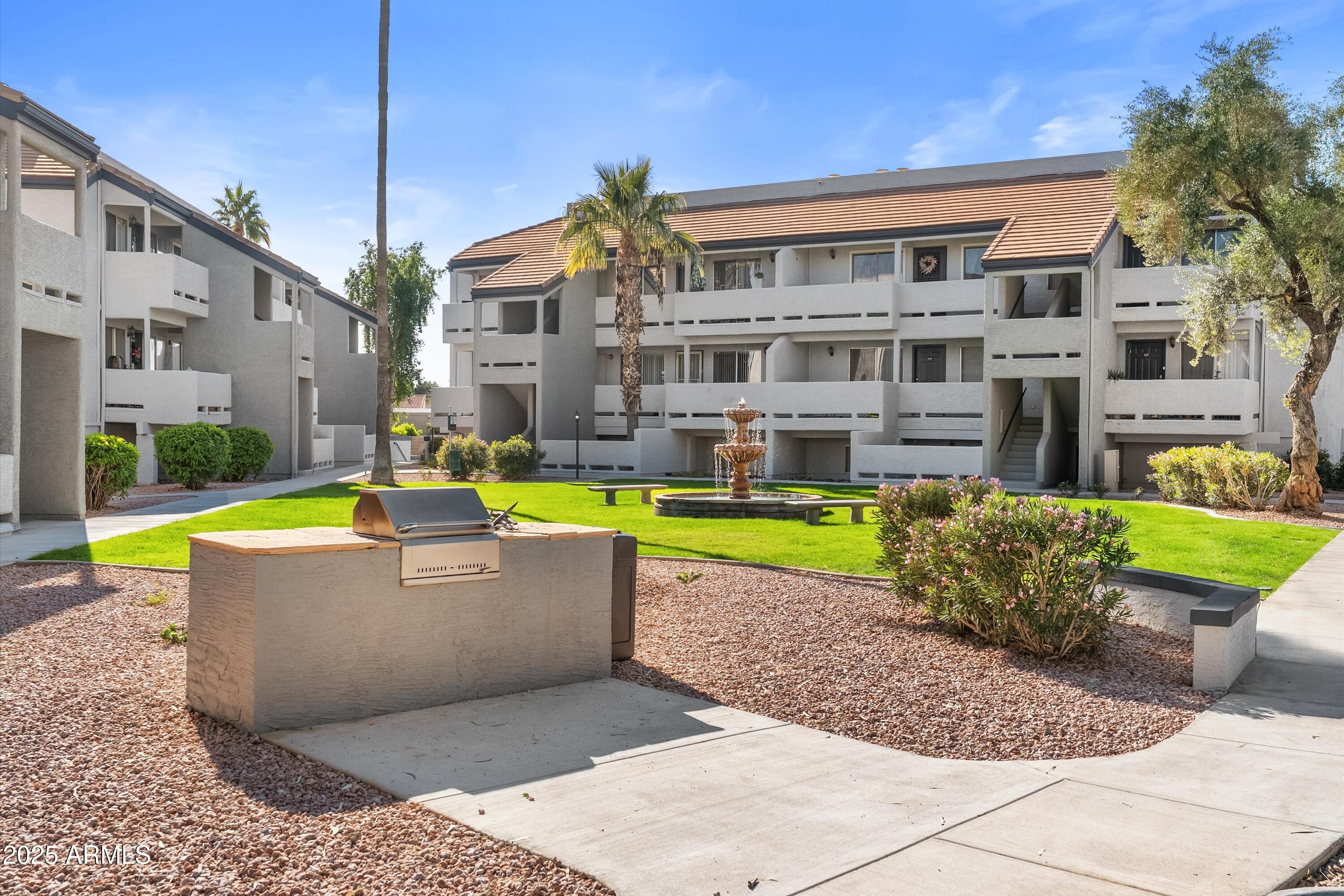 1331 West Baseline Road, Unit 338 Mesa, AZ 85202 - Photo 22 of 28 a view of a house with a swimming pool and a yard