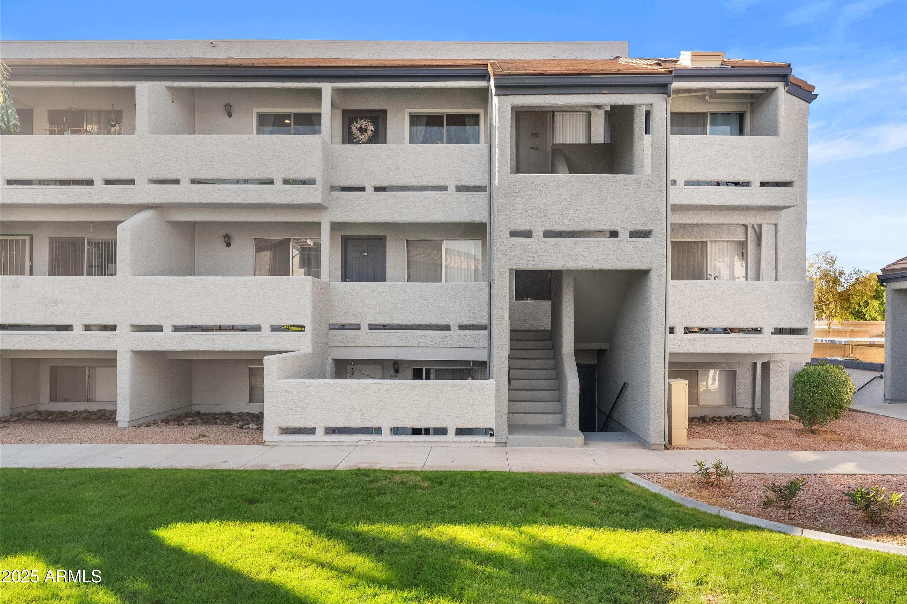 1331 West Baseline Road, Unit 338 Mesa, AZ 85202 - Photo 23 of 28 a front view of a house with a yard