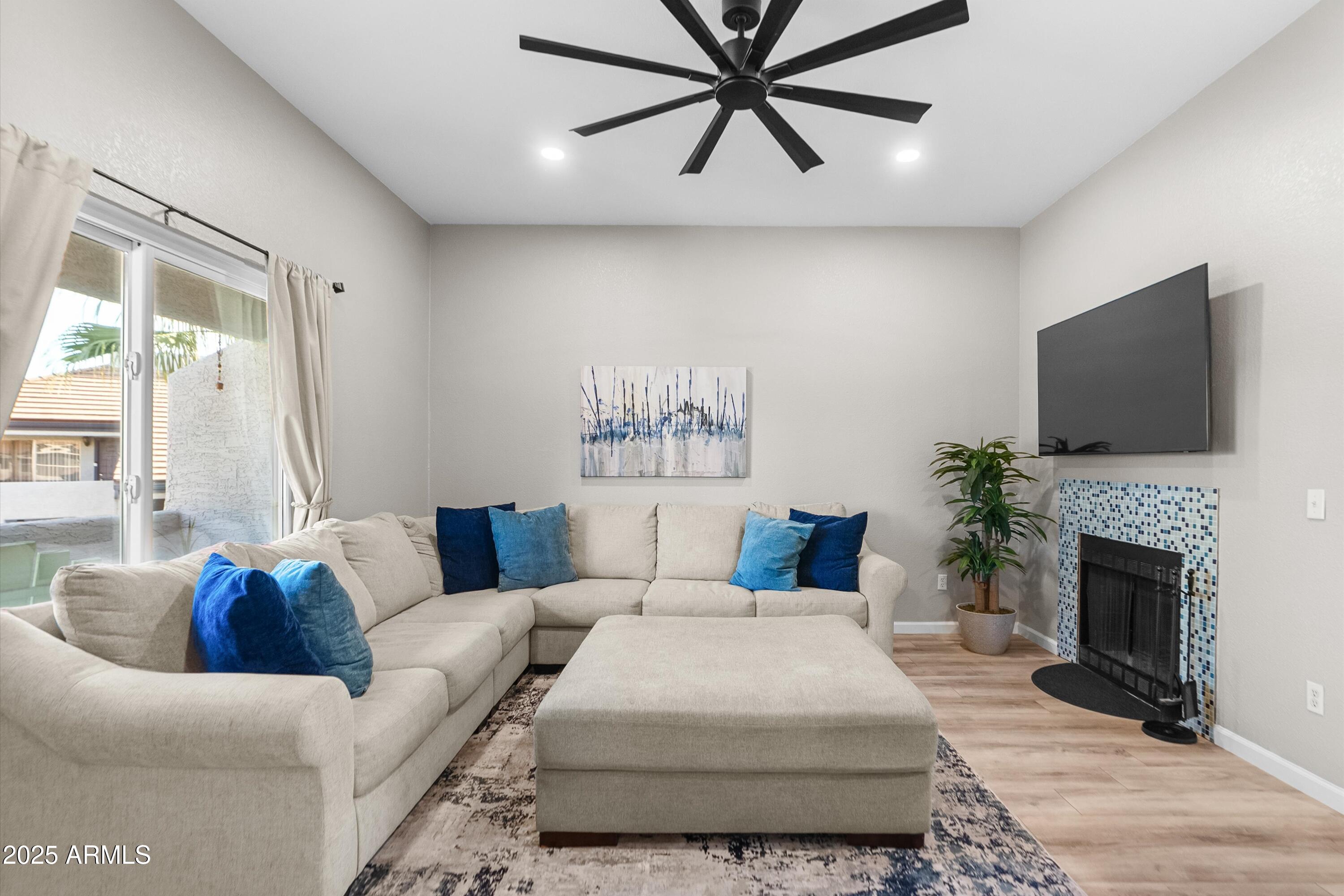 1331 West Baseline Road, Unit 338 Mesa, AZ 85202 - Photo 4 of 28 a living room with furniture a fireplace and a flat screen tv