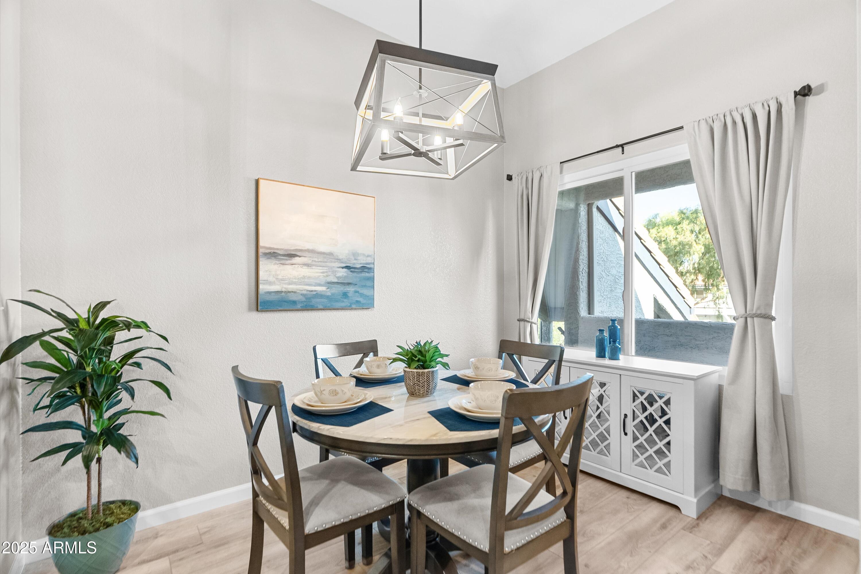 1331 West Baseline Road, Unit 338 Mesa, AZ 85202 - Photo 6 of 28 a view of a dining room with furniture window and wooden floor