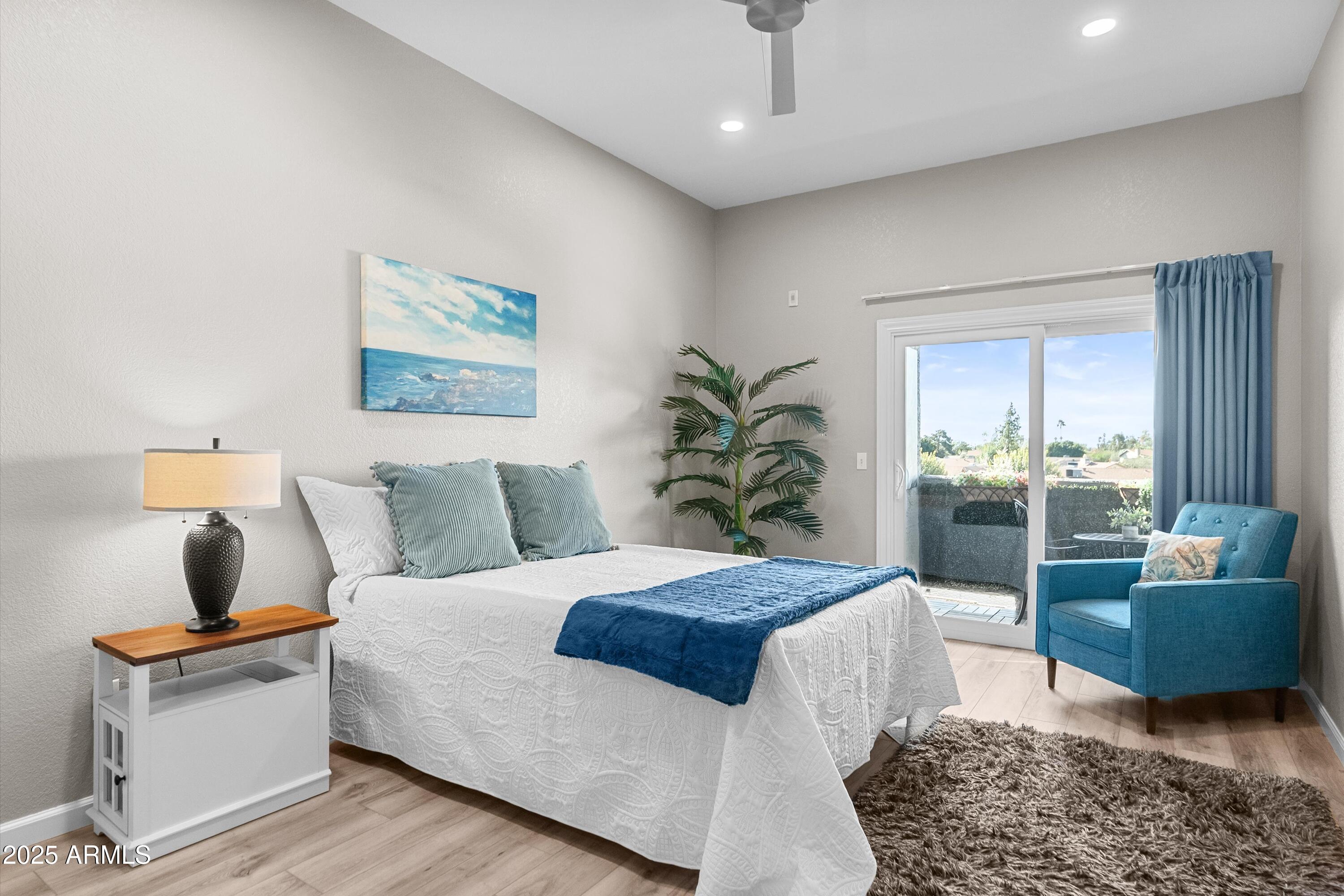 1331 West Baseline Road, Unit 338 Mesa, AZ 85202 - Photo 10 of 28 a bedroom with a large bed and a couch