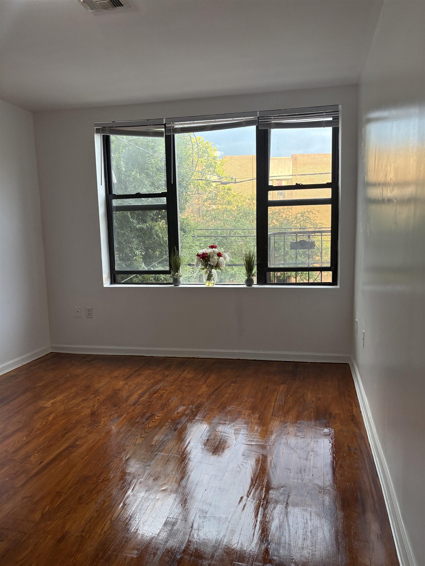 77 Crescent Avenue, Unit 5 Jersey City, NJ 07304 - Photo 11 of 18 an empty room with wooden floor and windows