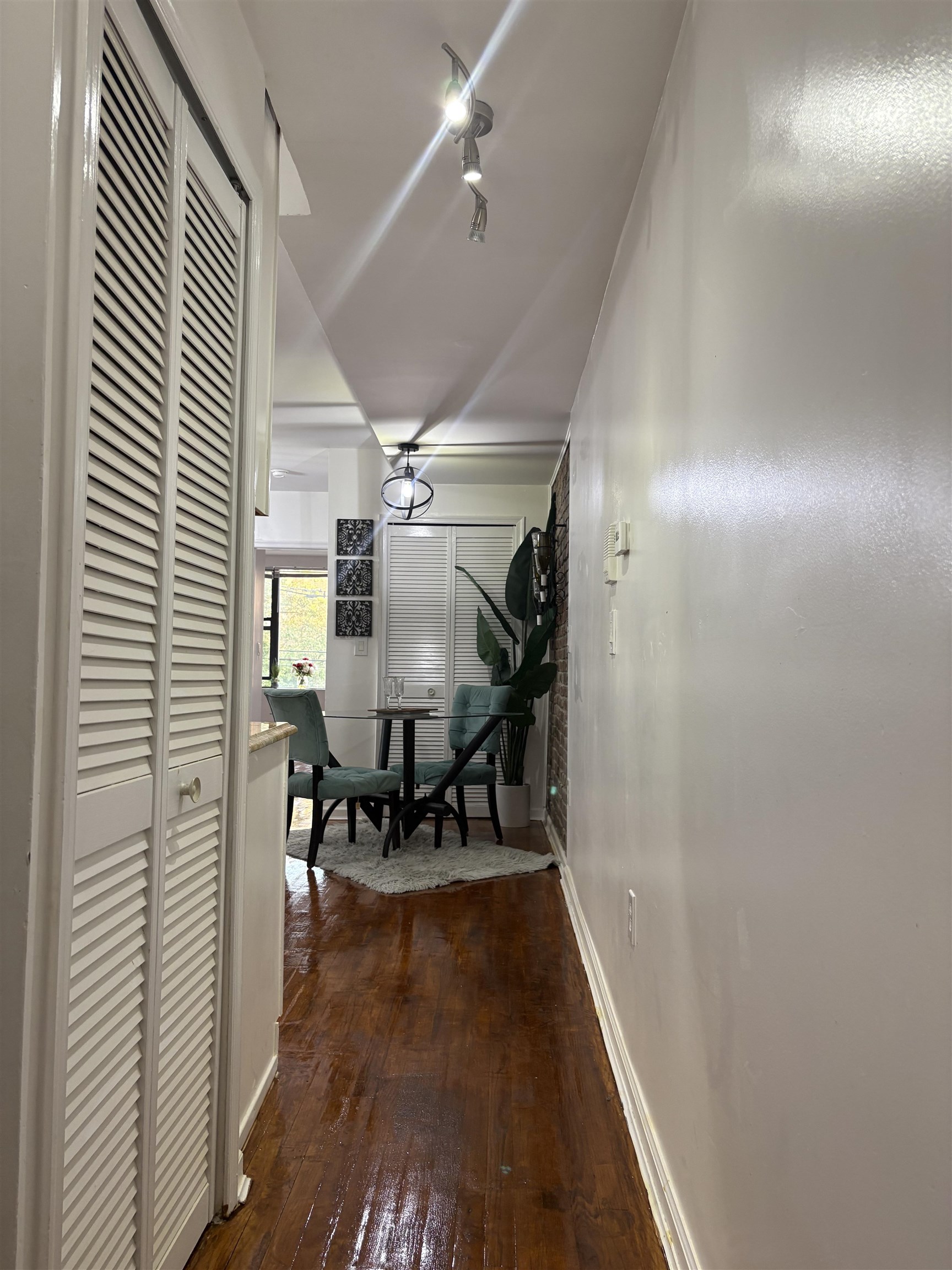 77 Crescent Avenue, Unit 5 Jersey City, NJ 07304 - Photo 17 of 18 a view of a hallway with wooden floor and staircase