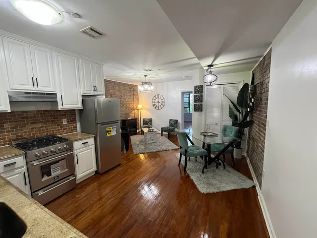 a kitchen with sink cabinets and wooden floor