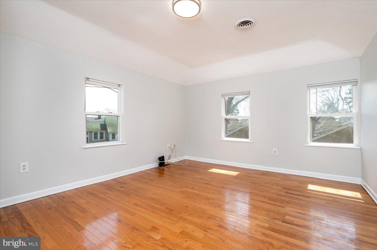 626 Clark Avenue Deale, MD 20751 - Photo 20 of 74 a view of an empty room with wooden floor and a window