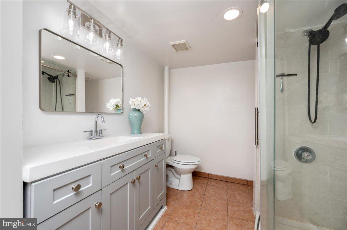 626 Clark Avenue Deale, MD 20751 - Photo 22 of 74 a bathroom with a granite countertop sink a toilet and a mirror