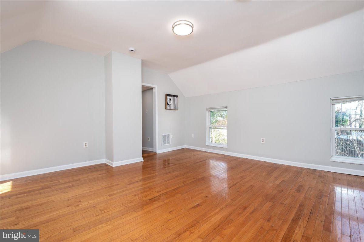 626 Clark Avenue Deale, MD 20751 - Photo 26 of 74 an empty room with wooden floor and windows
