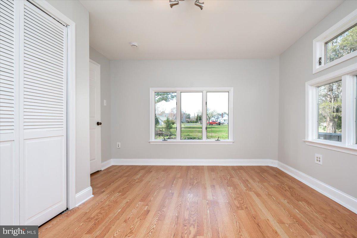 626 Clark Avenue Deale, MD 20751 - Photo 27 of 74 an empty room with wooden floor and windows