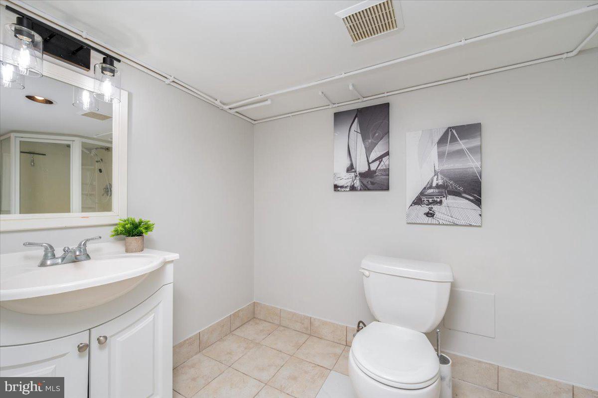 626 Clark Avenue Deale, MD 20751 - Photo 28 of 74 a bathroom with a toilet sink and mirror