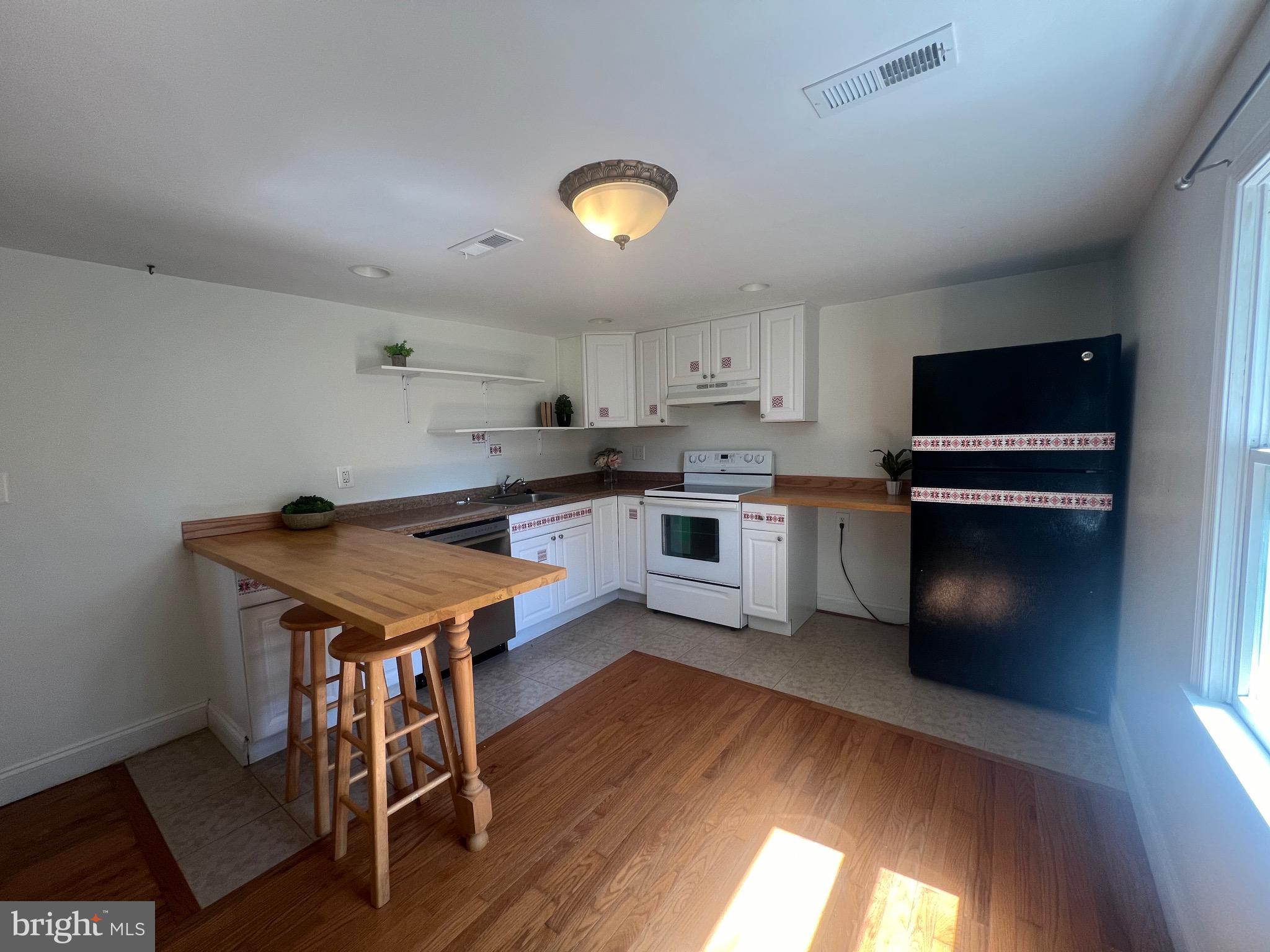 626 Clark Avenue Deale, MD 20751 - Photo 33 of 74 a kitchen with a stove a refrigerator and a microwave