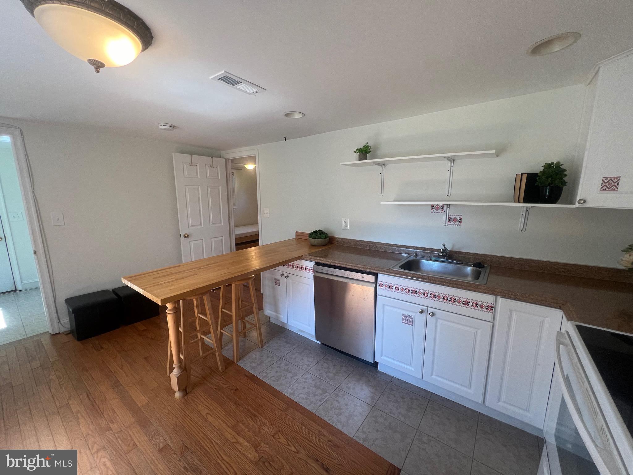 626 Clark Avenue Deale, MD 20751 - Photo 34 of 74 a kitchen with granite countertop a sink cabinets and wooden floor