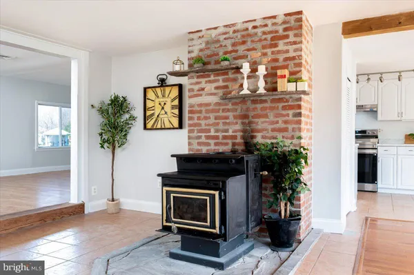 an empty room with wooden floor a painting on the wall and a window