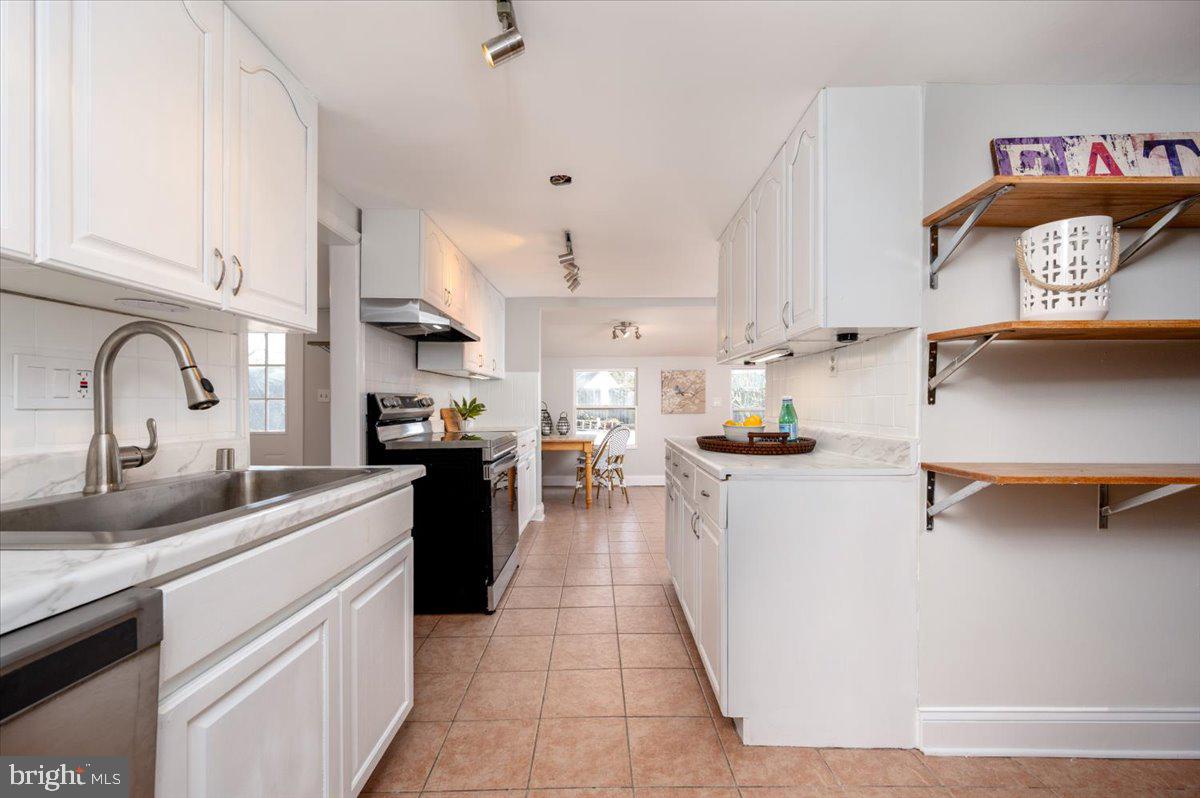 626 Clark Avenue Deale, MD 20751 - Photo 7 of 74 a kitchen with kitchen island granite countertop a sink appliances cabinets and a counter top space