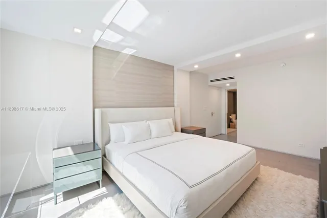 a bedroom with a bed and a night stand