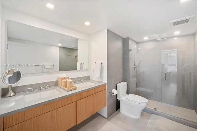 a bathroom with a double vanity sink toilet and shower