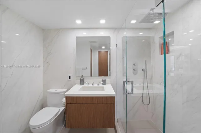 a bathroom with a toilet sink shower and mirror