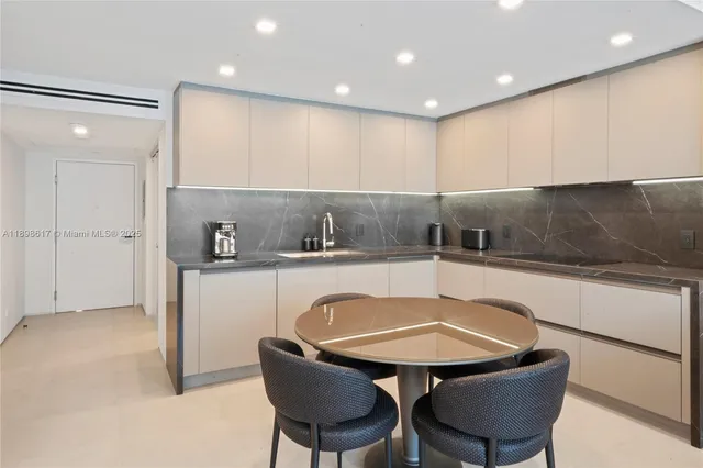 a kitchen with a table and chairs in it