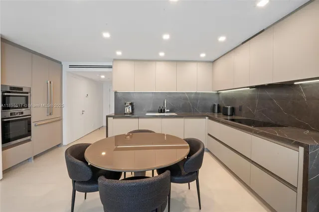 a kitchen with a table and chairs in it