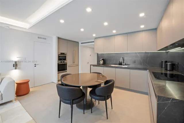 a large kitchen with a table and chairs