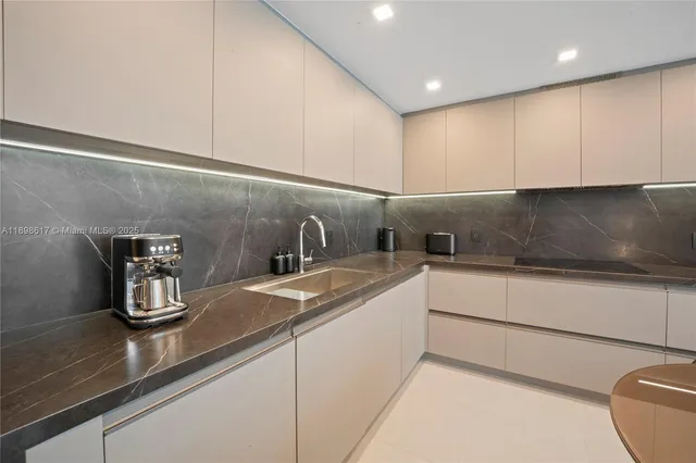 a kitchen with a sink dishwasher and cabinets