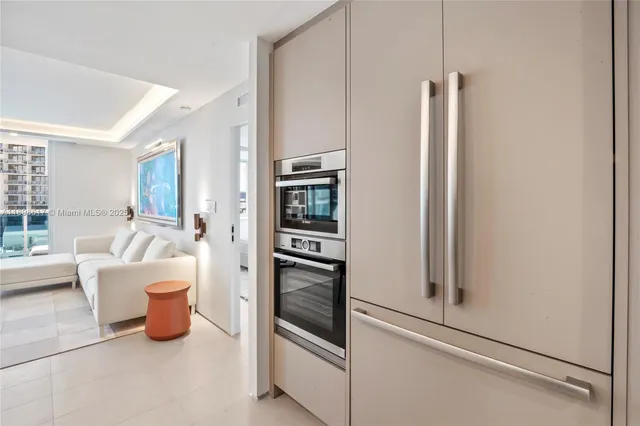 a kitchen with stainless steel appliances a refrigerator and a window
