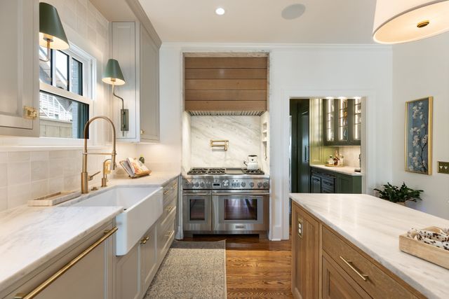 a kitchen with stainless steel appliances granite countertop a stove and a sink