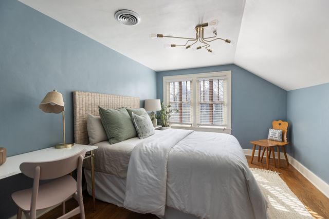 a bedroom with a bed and a large mirror