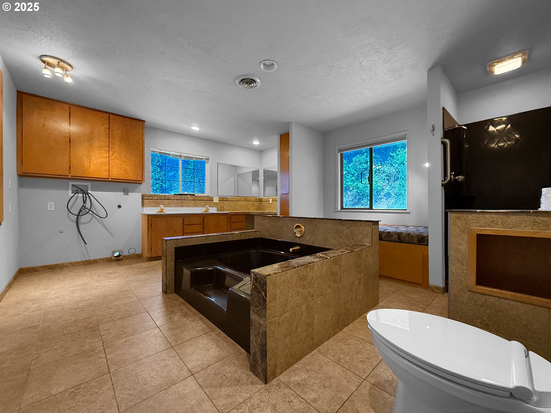 96741 Duley Creek Road Brookings, OR 97415 - Photo 16 of 36 a kitchen with a sink a stove a microwave a counter top space and cabinets