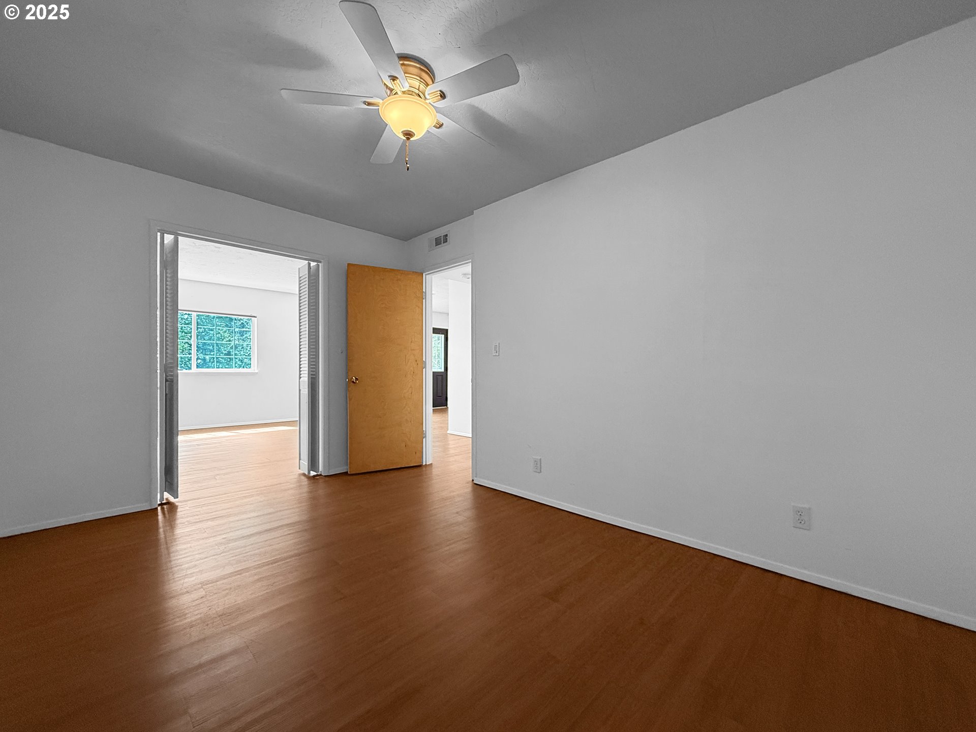 96741 Duley Creek Road Brookings, OR 97415 - Photo 24 of 36 a view of an empty room with window and wooden floor