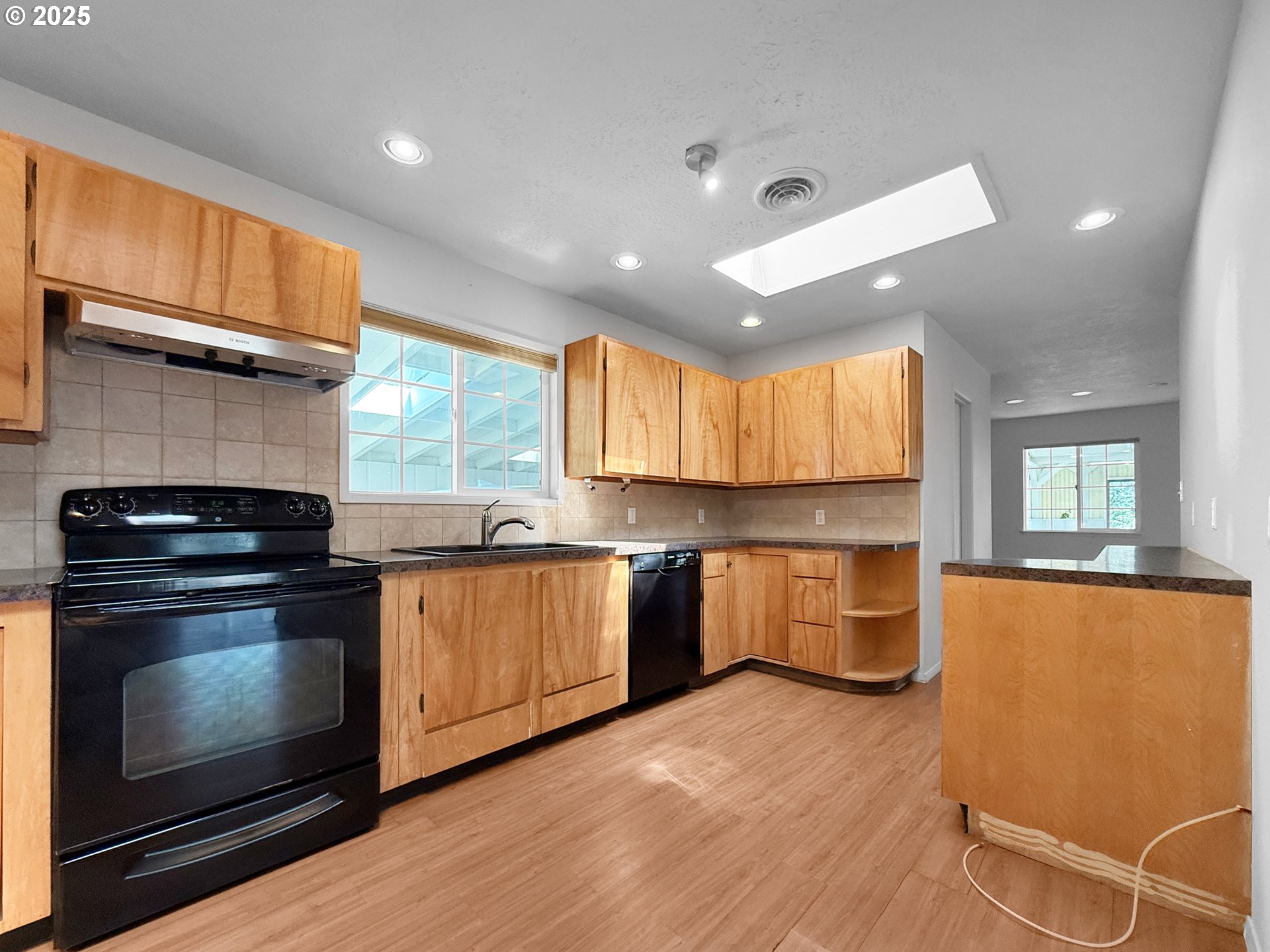 96741 Duley Creek Road Brookings, OR 97415 - Photo 9 of 36 a kitchen with stainless steel appliances granite countertop a stove a sink and a refrigerator