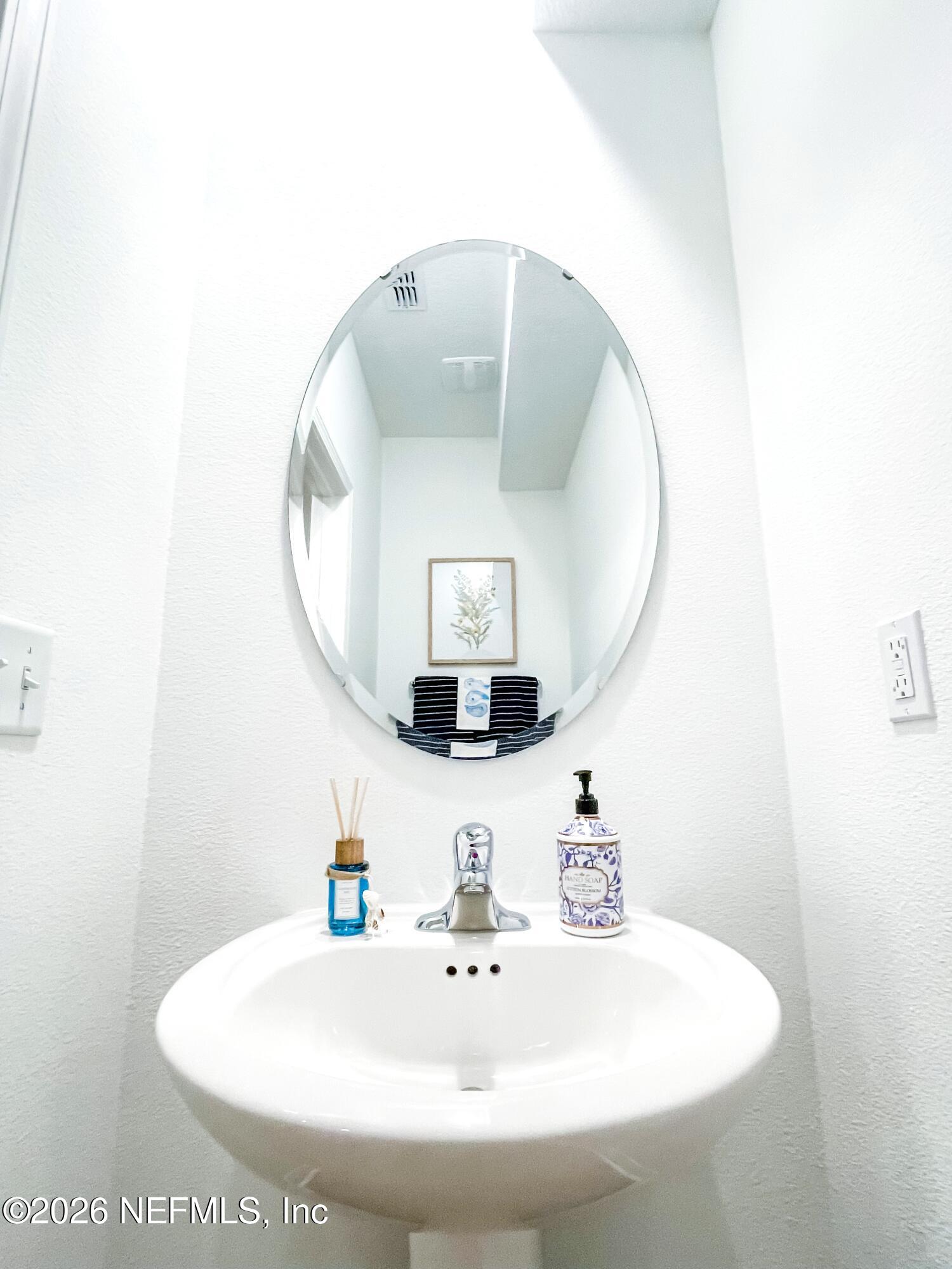 113 Palma Drive St. Augustine, FL 32086 - Photo 9 of 16 a bathroom with a sink and a mirror