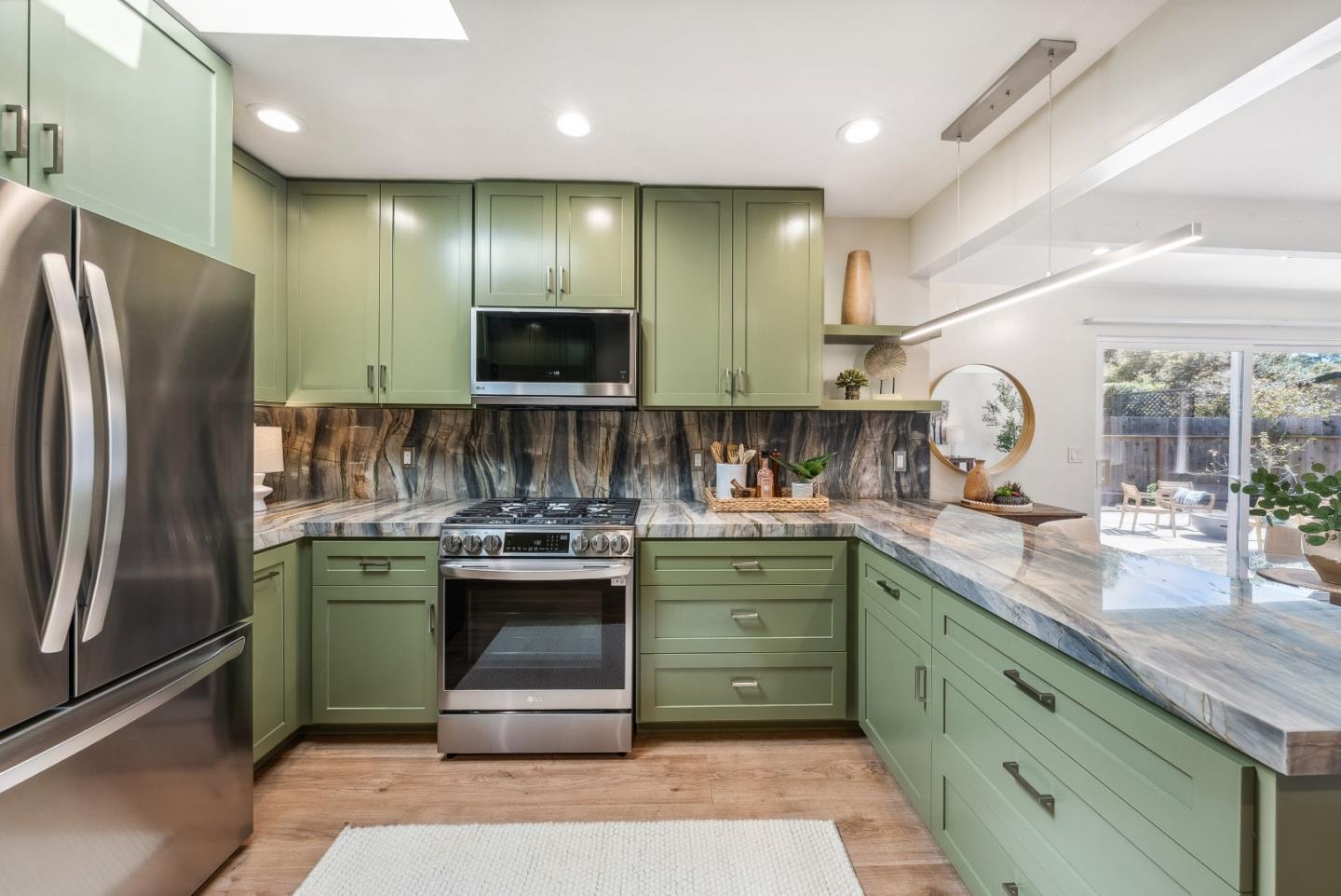743 Marino Pines Road Pacific Grove, CA 93950 - Photo 16 of 55 a kitchen with kitchen island a sink stainless steel appliances and cabinets