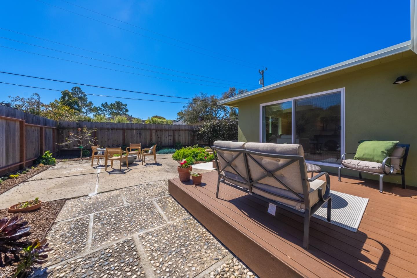 743 Marino Pines Road Pacific Grove, CA 93950 - Photo 38 of 55 a view of a patio with a table and chairs and potted plants