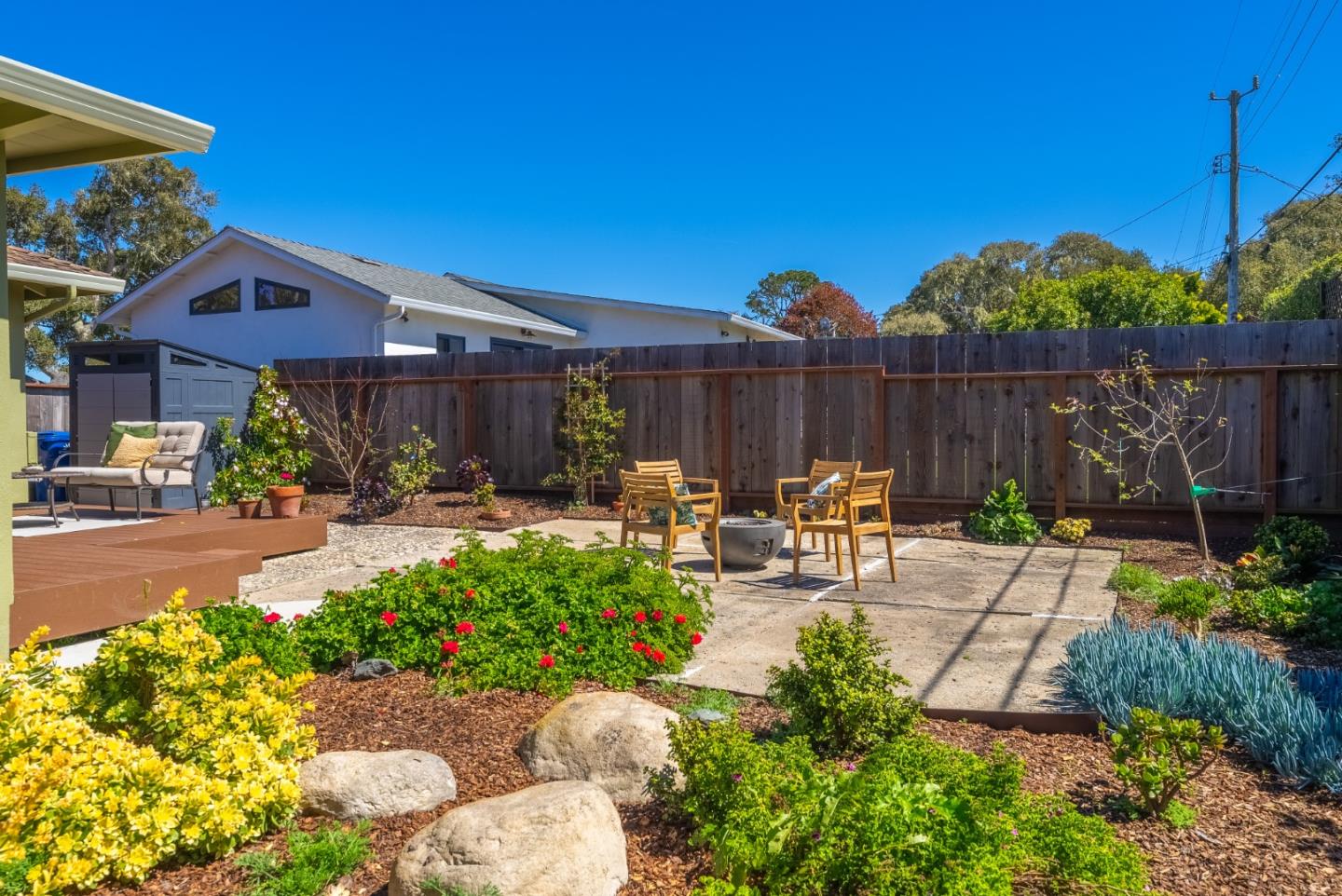 743 Marino Pines Road Pacific Grove, CA 93950 - Photo 41 of 55 a view of a patio with table and chairs potted plants with wooden fence