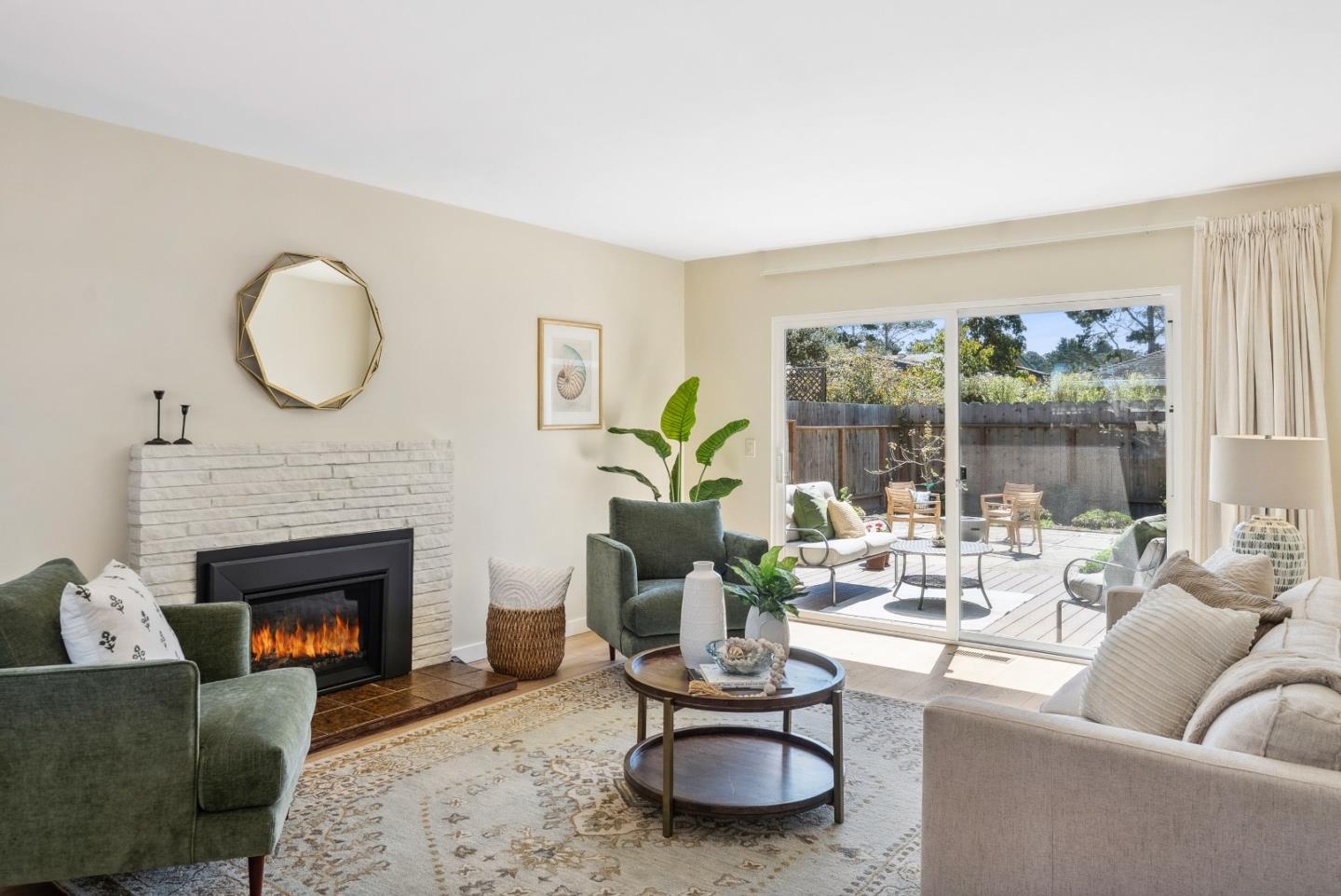 743 Marino Pines Road Pacific Grove, CA 93950 - Photo 5 of 55 a living room with furniture a fireplace and a floor to ceiling window