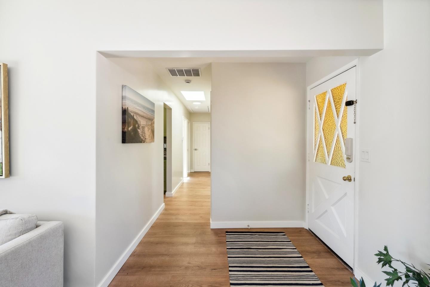 743 Marino Pines Road Pacific Grove, CA 93950 - Photo 10 of 55 a view of a hallway with wooden floor and a bathroom