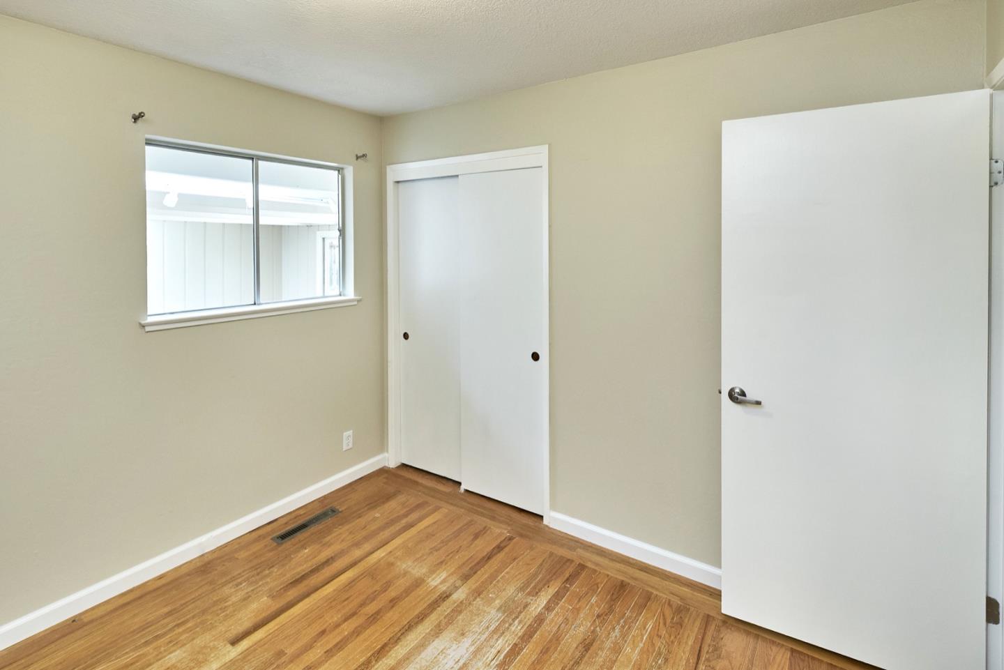 4841 Borina Drive San Jose, CA 95129 - Photo 15 of 26 a view of an empty room with wooden floor and a window
