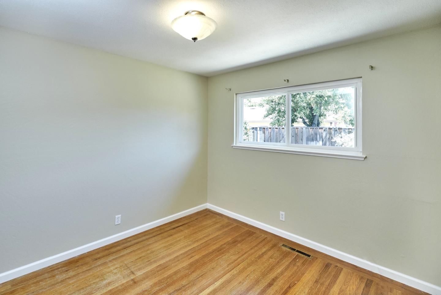 4841 Borina Drive San Jose, CA 95129 - Photo 17 of 26 an empty room with wooden floor and windows