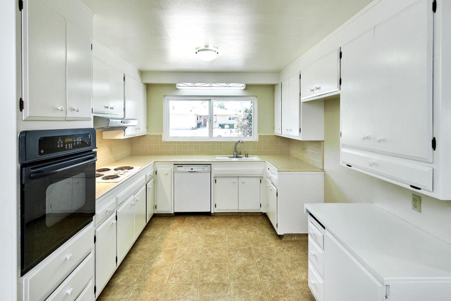 4841 Borina Drive San Jose, CA 95129 - Photo 7 of 26 a kitchen with a sink stove and cabinets