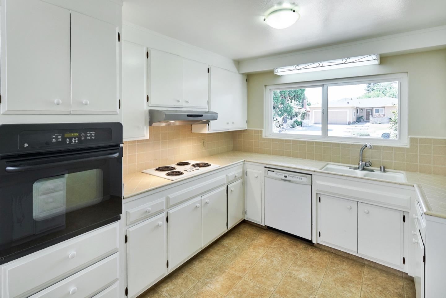 4841 Borina Drive San Jose, CA 95129 - Photo 8 of 26 a kitchen with granite countertop white cabinets and white appliances