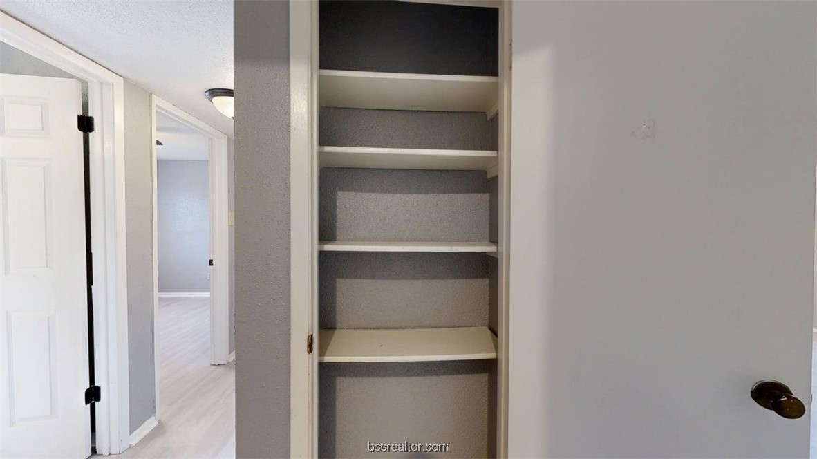 1524 Pine Ridge Drive, Unit B College Station, TX 77840 - Photo 18 of 21 a view of walk in closet with empty racks